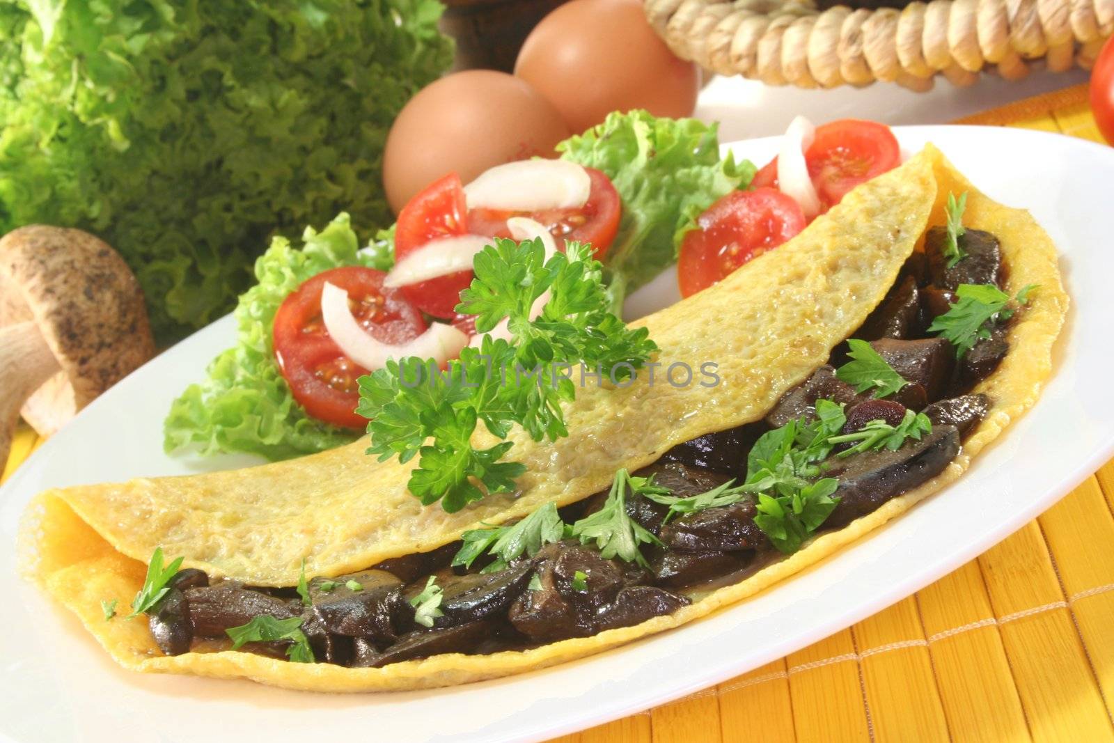 an omelet stuffed with wild mushrooms and fresh salad