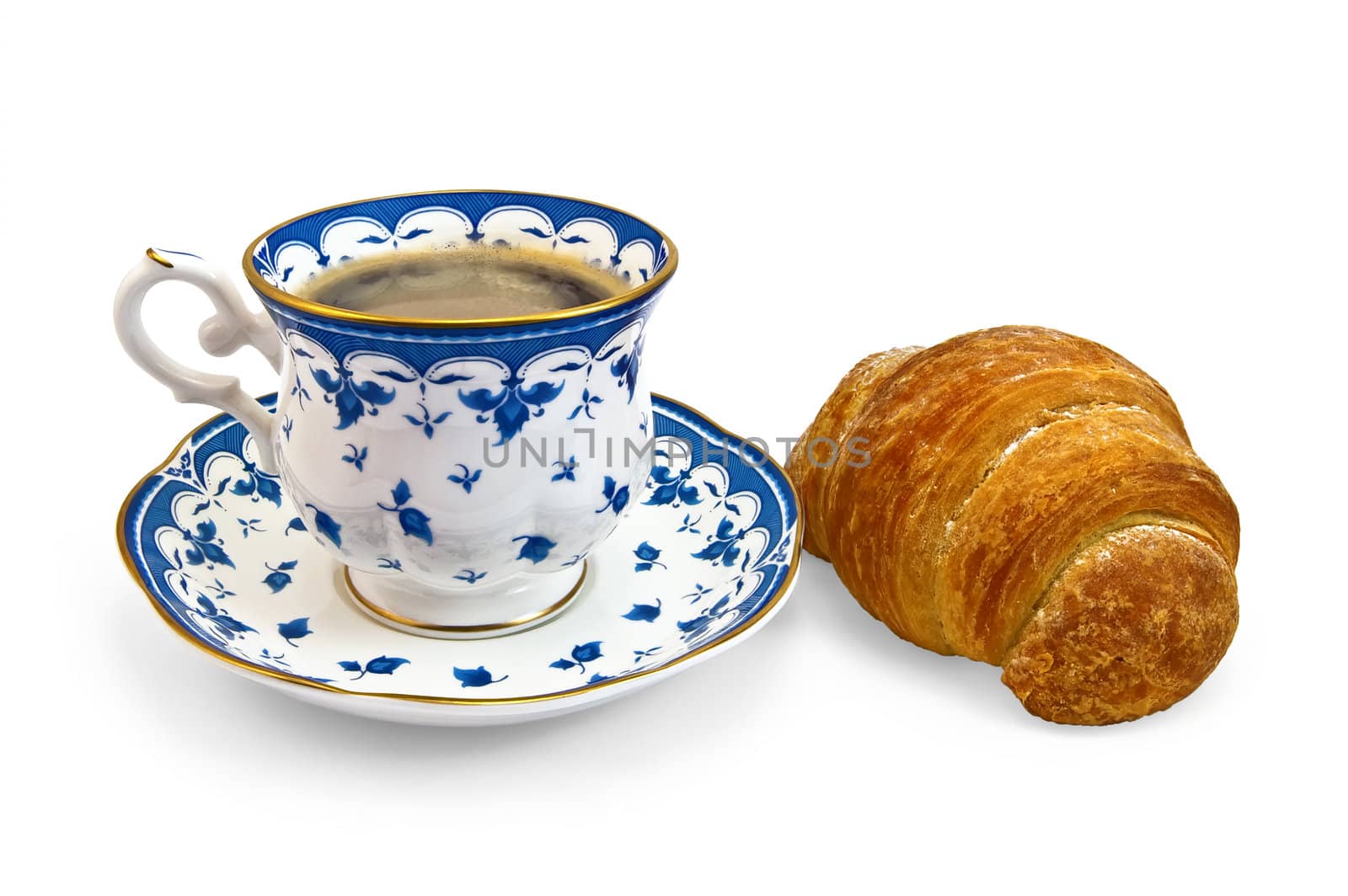 Coffee in a porcelain cup with a blue pattern and croissant isolated on a white background