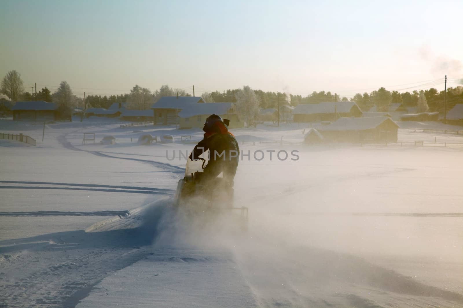 Snowmobile at full speed. Winter landscape.