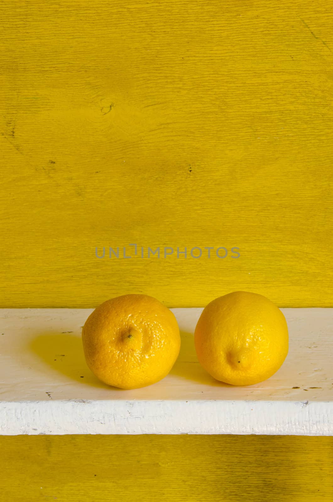 Couple of lemon on a shelf. Eating healthy fruits.