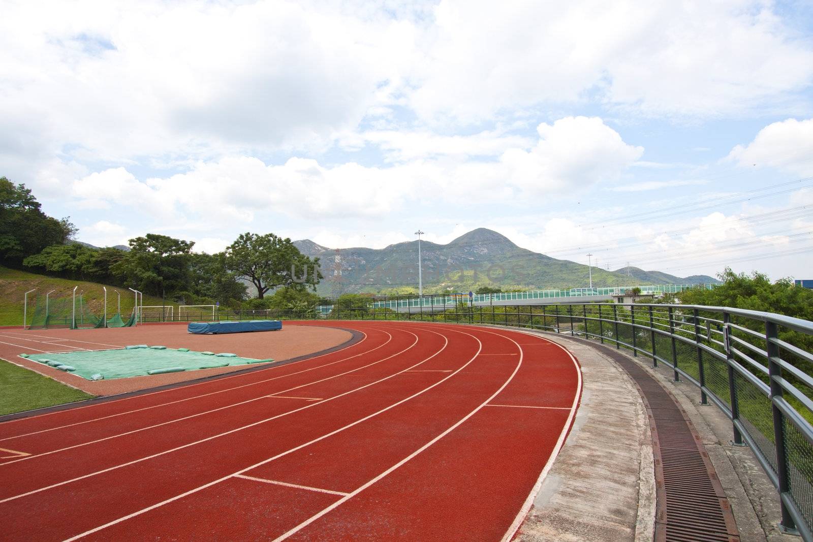 Sports stadium with running track at day