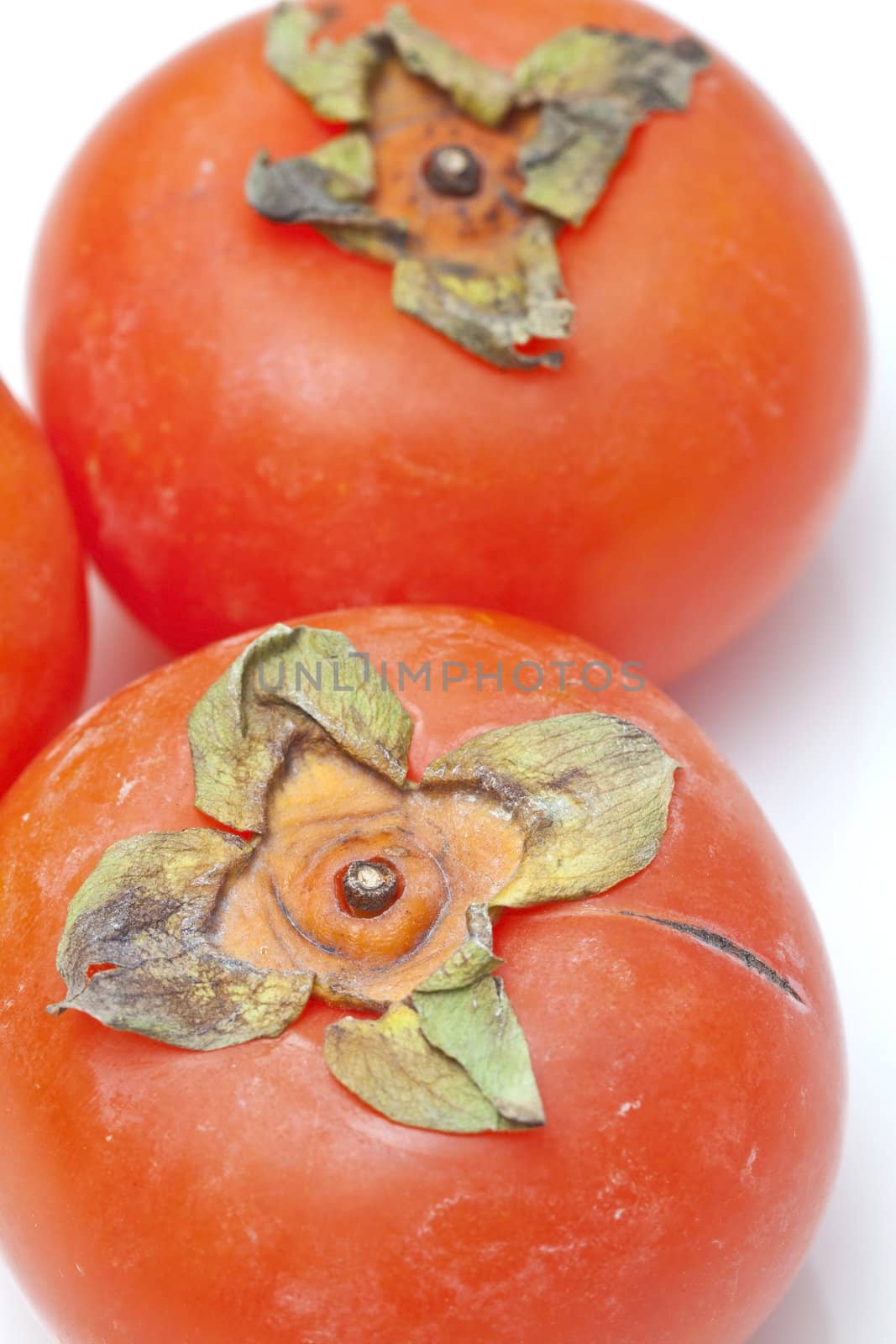Orange persimmons isolated on white background by kawing921