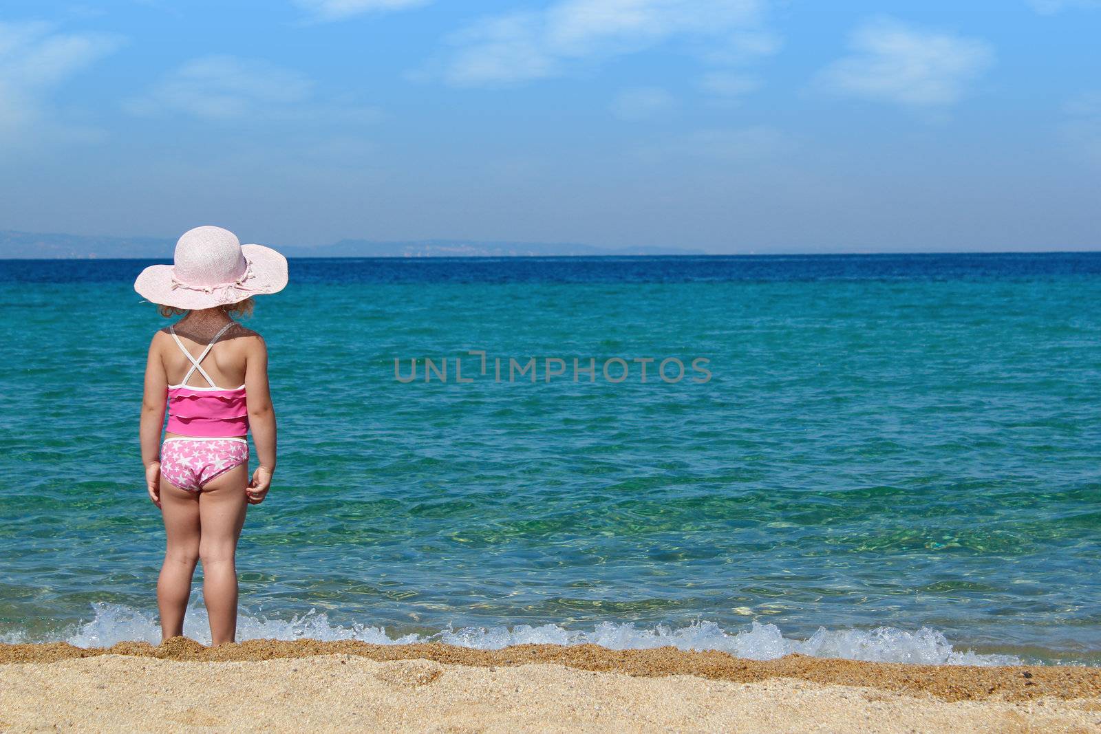 little girl looking at sea by goce