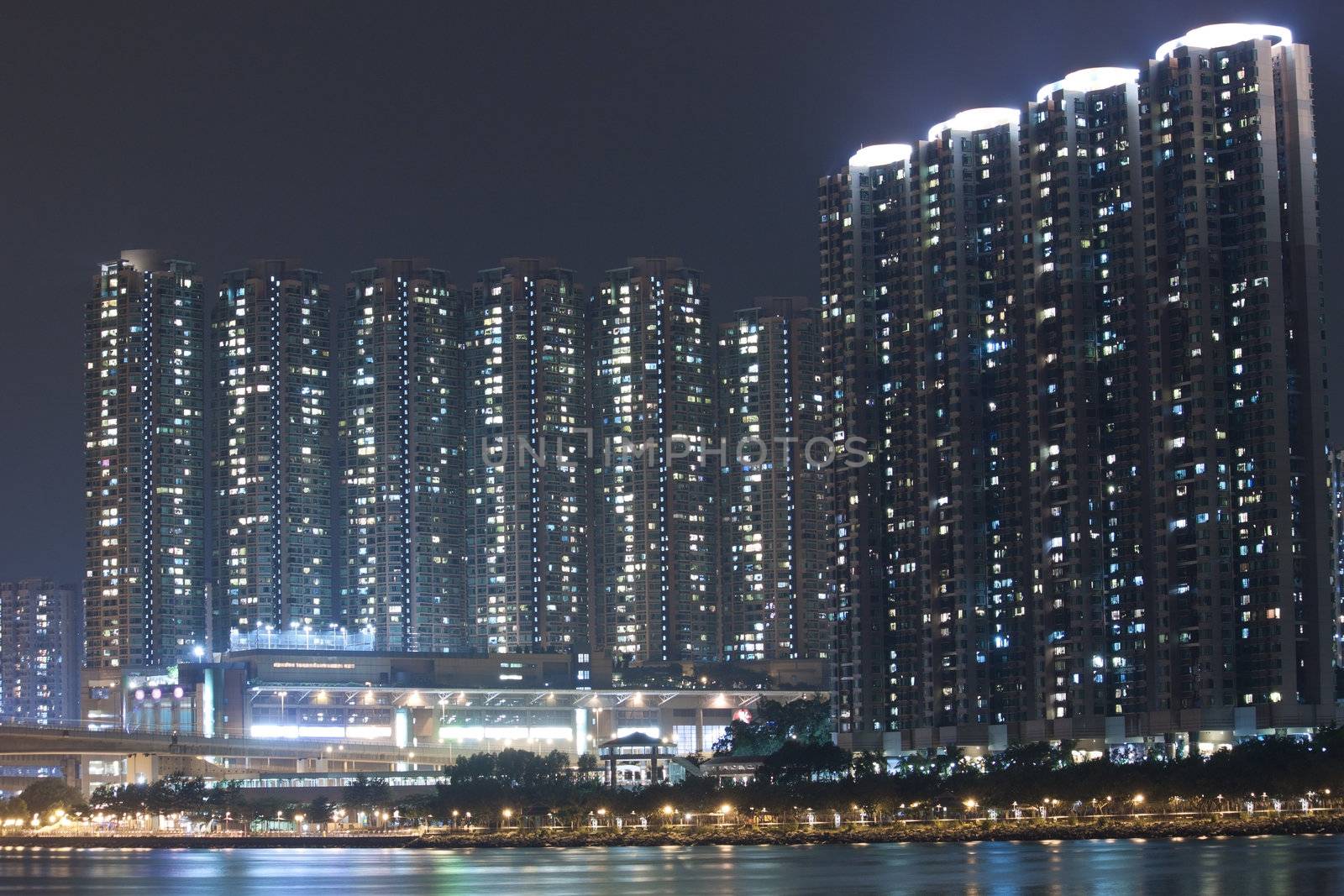 Hong Kong apartment blocks at night, showing the packed conditio by kawing921