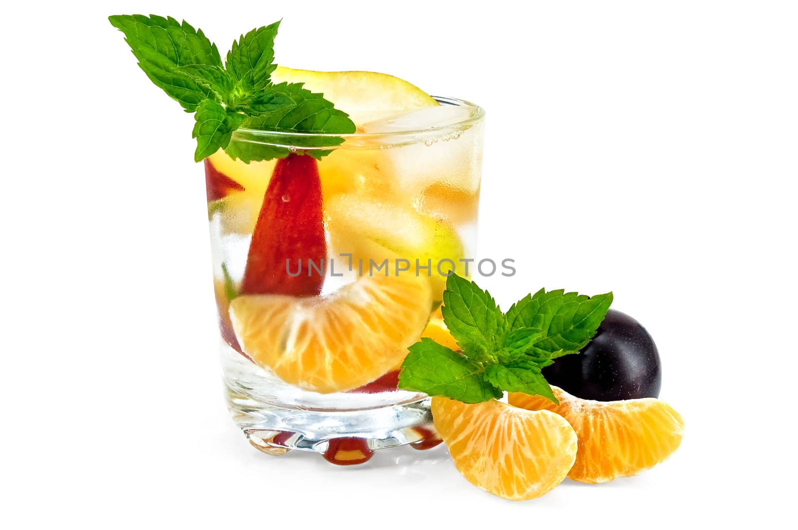 Fruit cocktail of pear, tangerine, peach and mint with ice in a glass, slices of mandarin, plum isolated on a white background