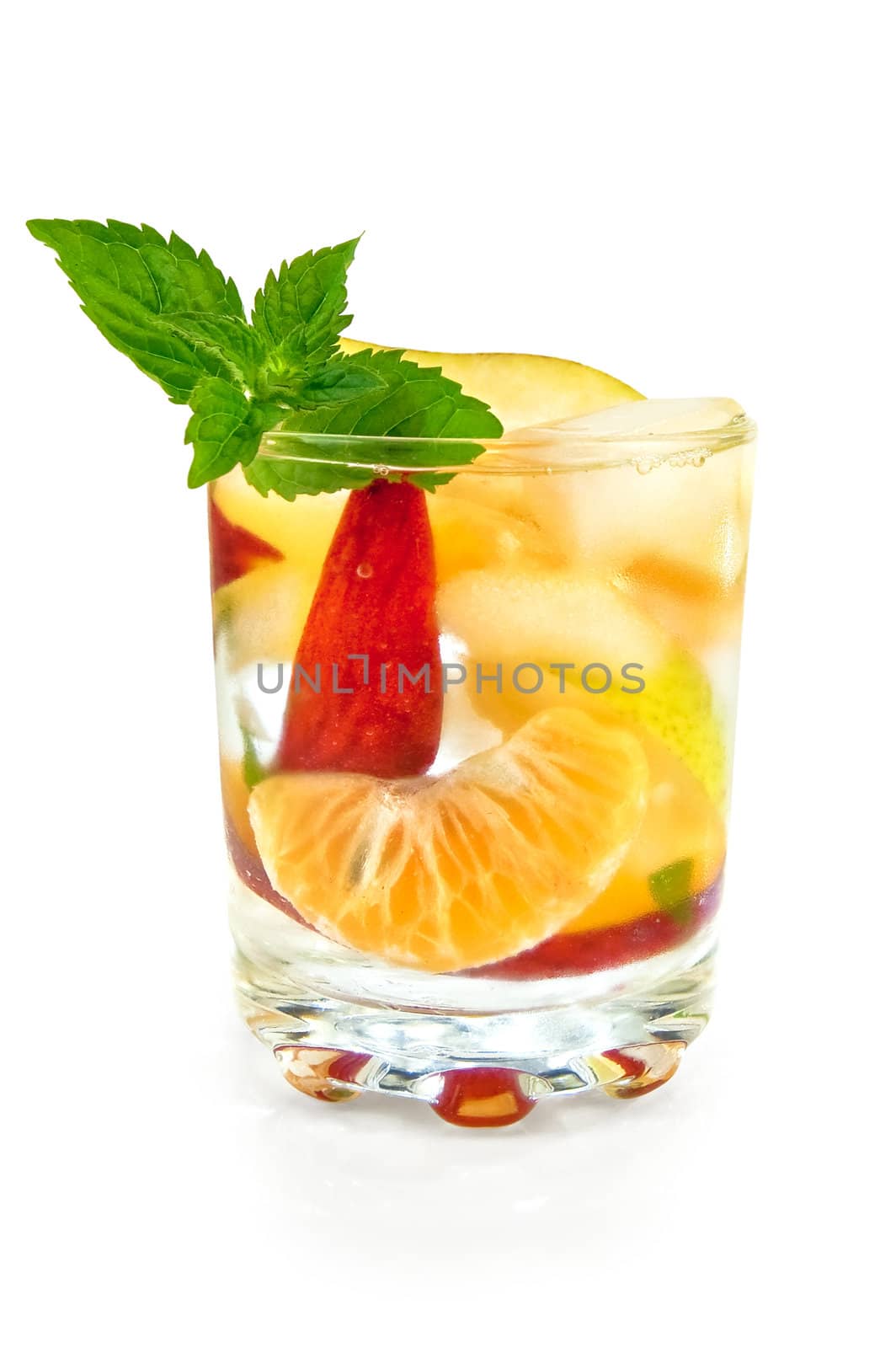 Fruit cocktail of pear, tangerine, peach and mint with ice in a glass isolated on white background