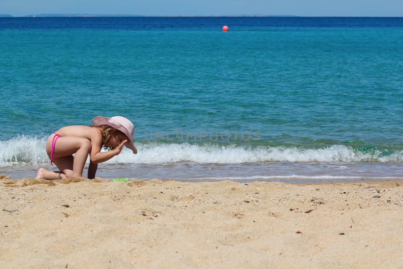 little girl playing on the beach by goce