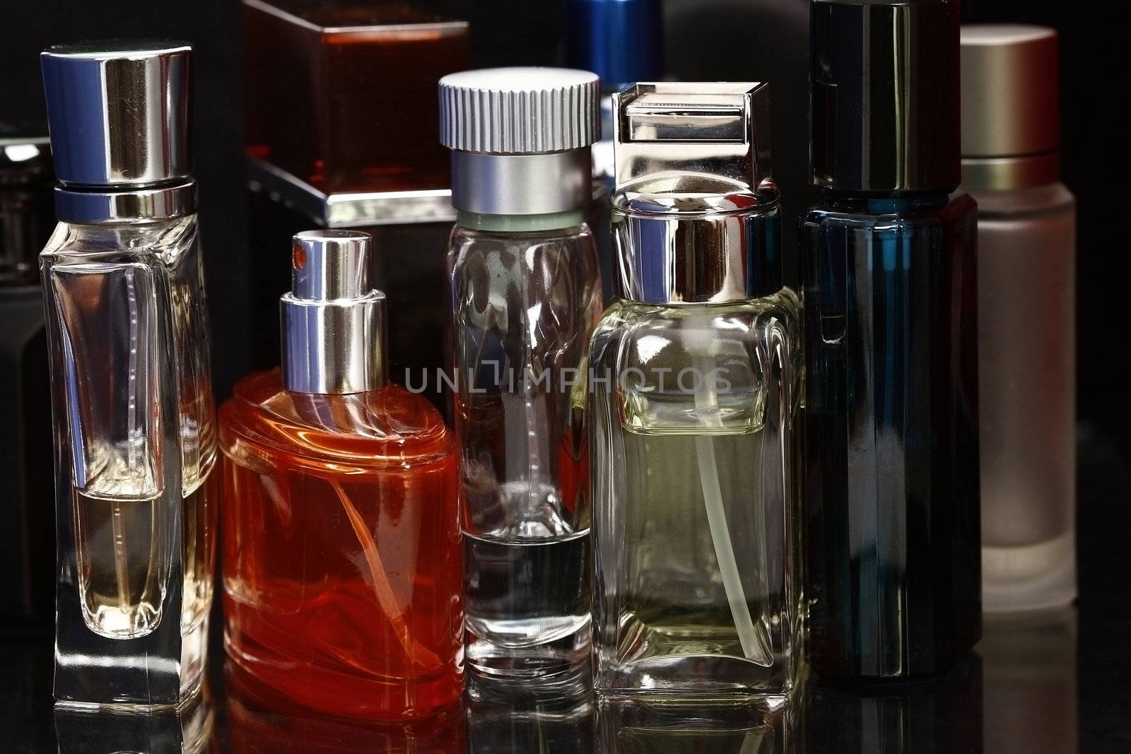 Perfume and fragrances bottles in black background. No logo.