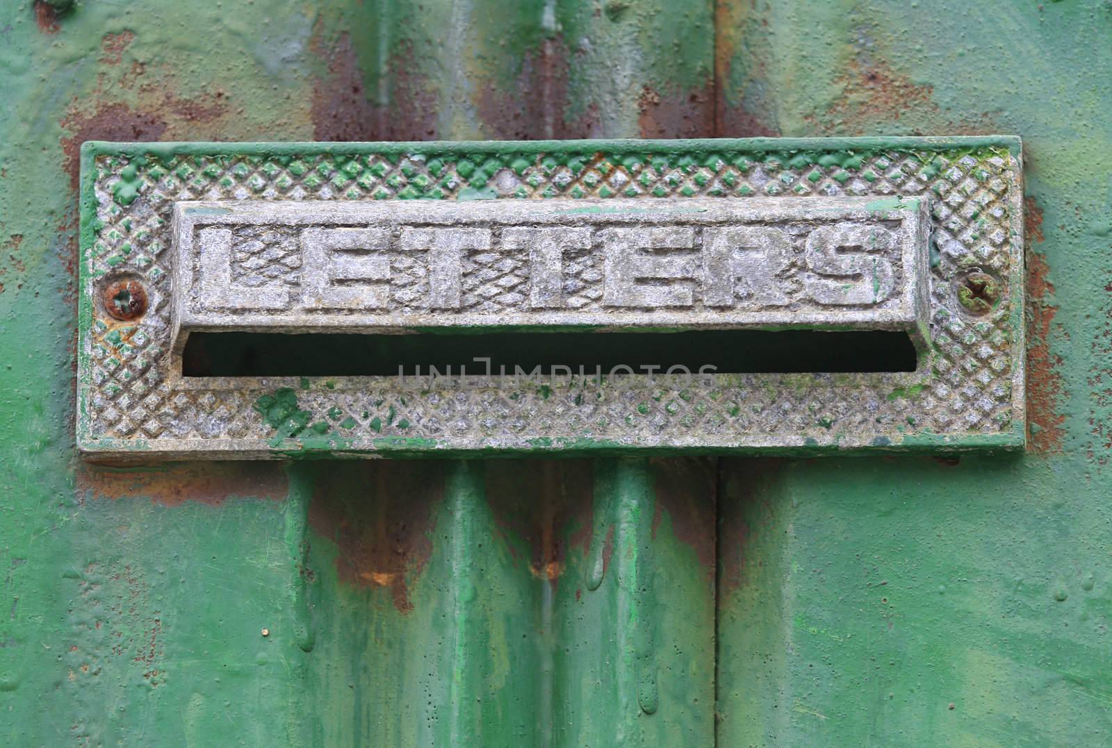 Old mailbox with letters engrave in a rusty green painted doorcan be found in korea.