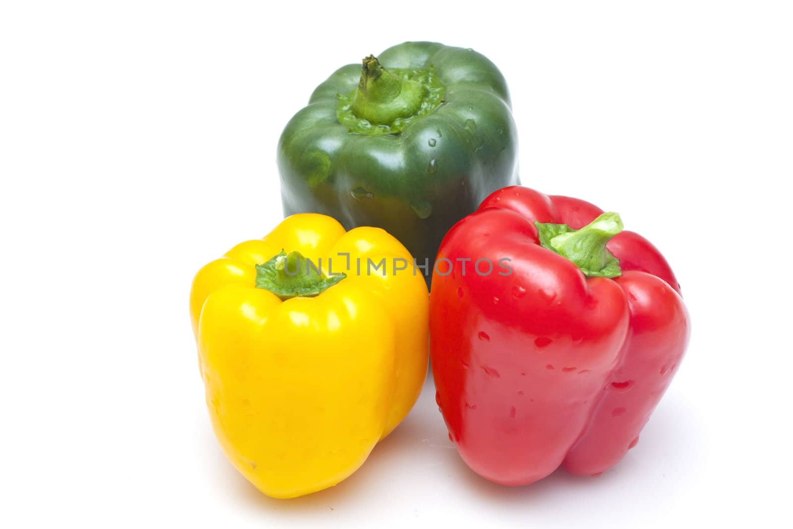Bell peppers (green, yellow and red) isolated on white background