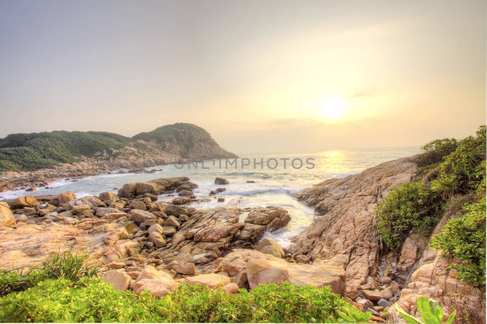 Sea stones along the coast at sunrise by kawing921