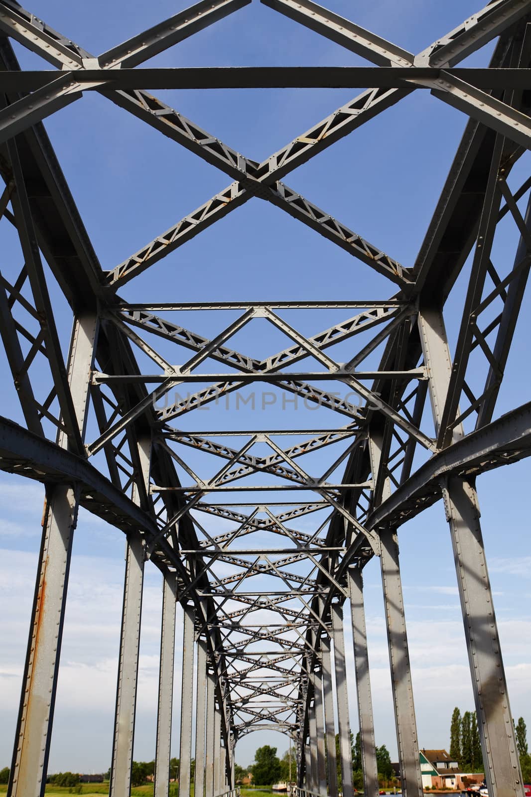 Old iron railway bridge with blue sky background