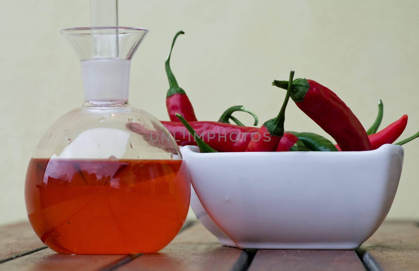 Hot peppers and spicy oil on a table