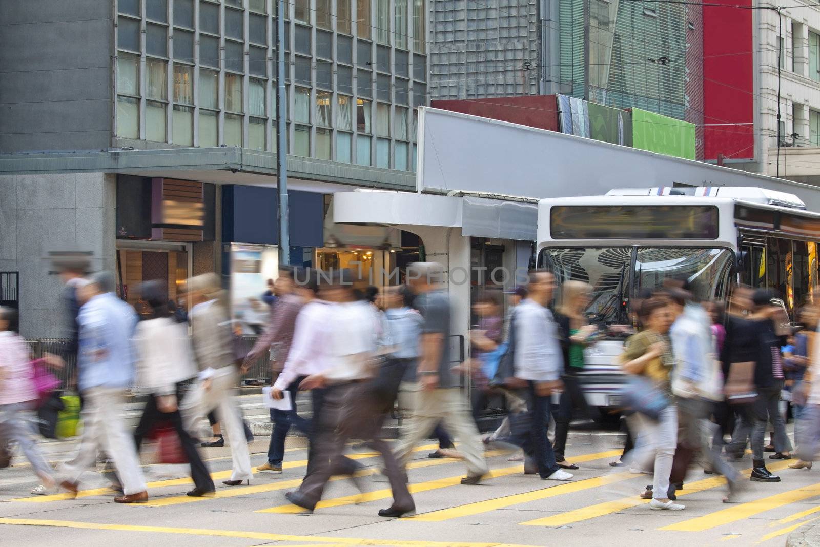 Moving pedestrian in business district, blurred motion.