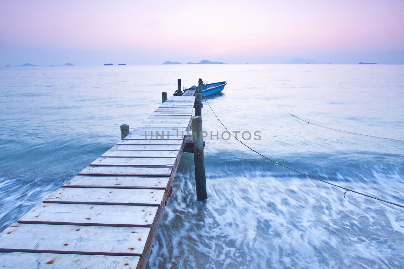 Jetty sunset along coast with waves movement