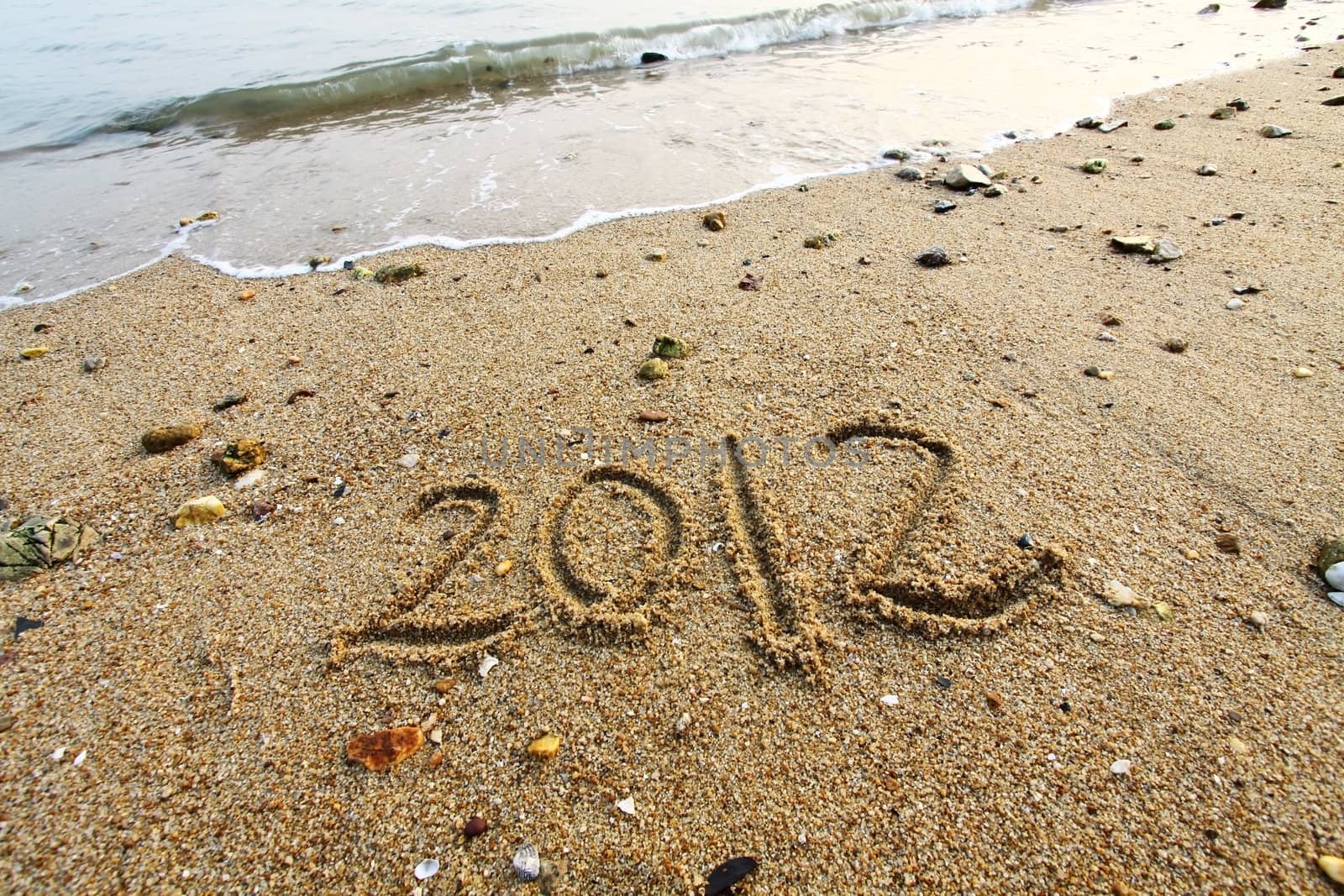 2012 year written on the beach sand