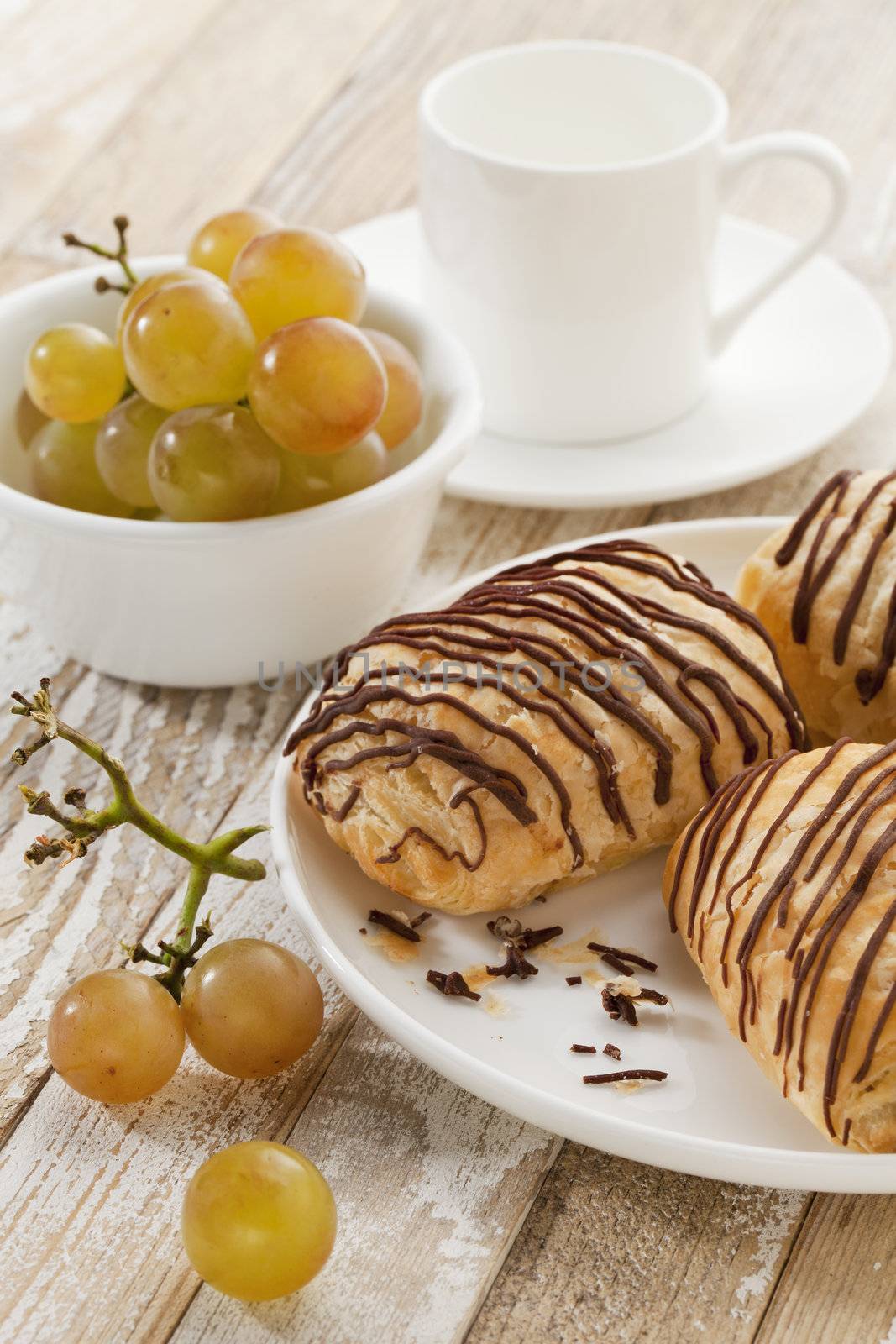 chocolate croissants, grapes and coffee by PixelsAway