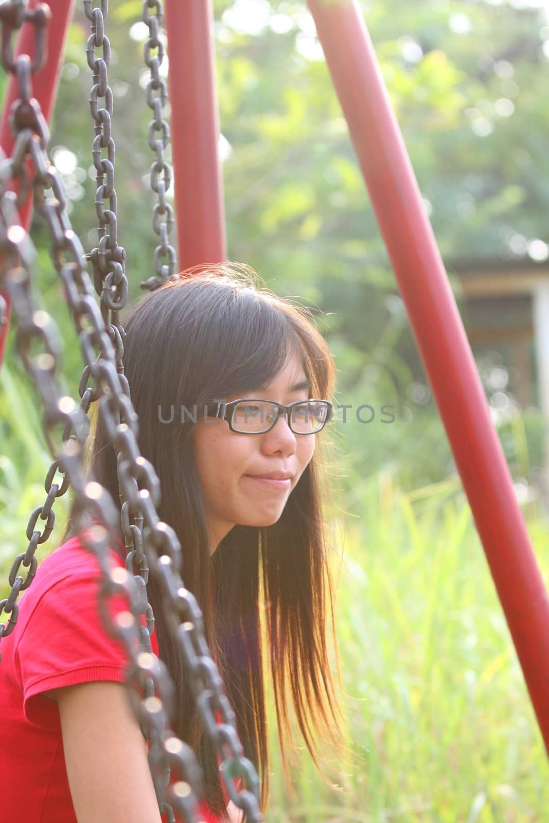 Asian girl smiling in a park