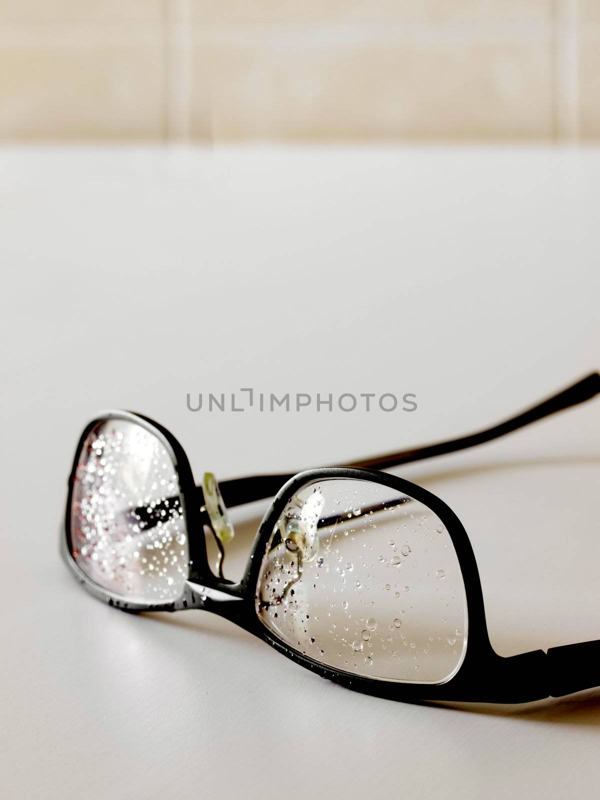 close up of wet eye glasses in bathroom