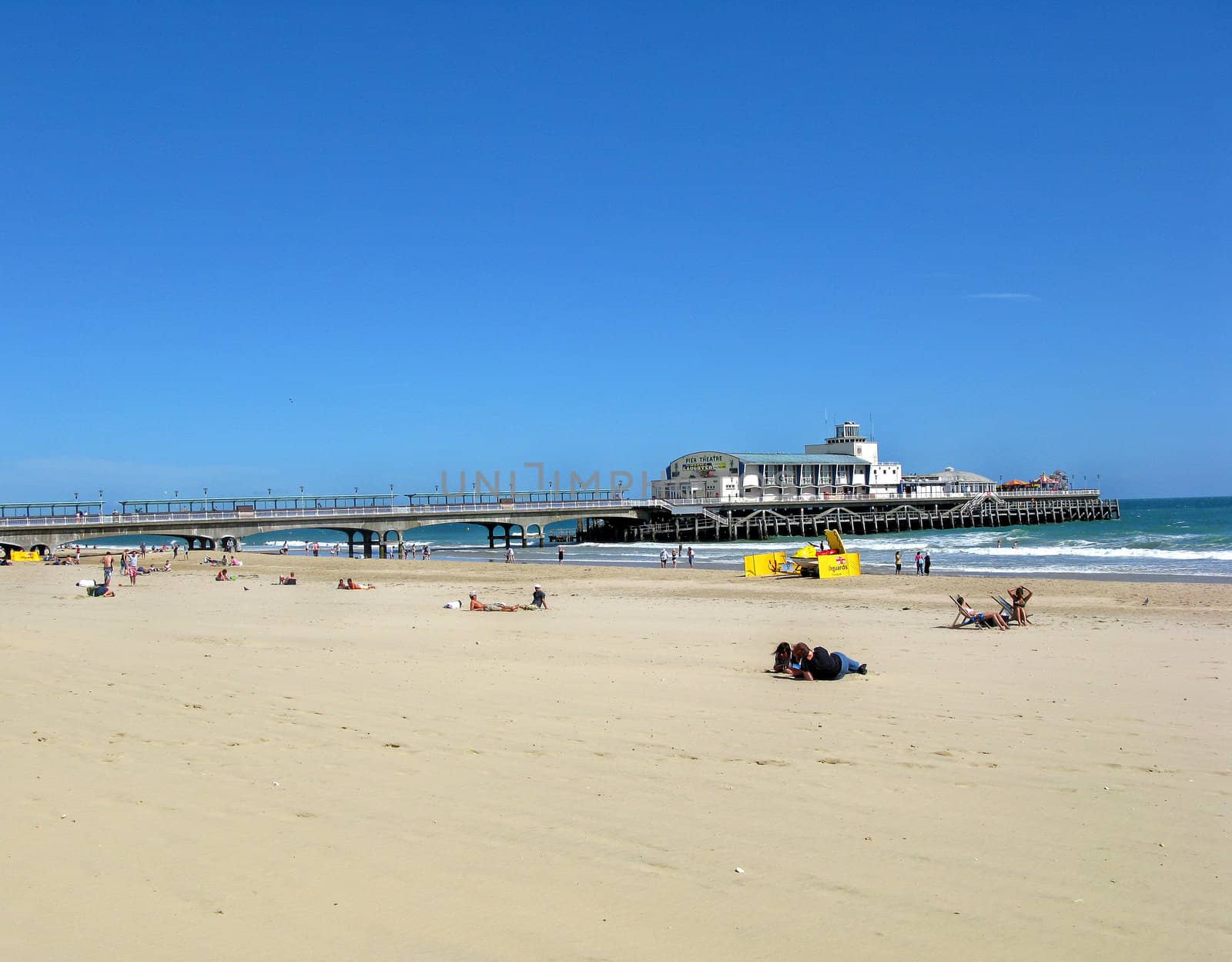 A view of a beach, sea in a pier.