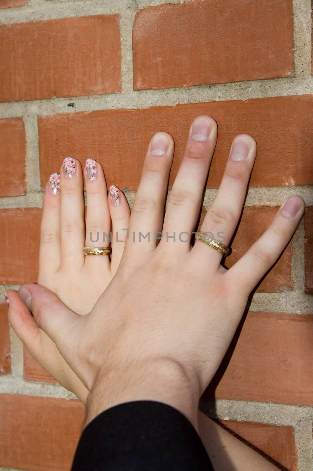 Hands on a brick wall by Ravenestling