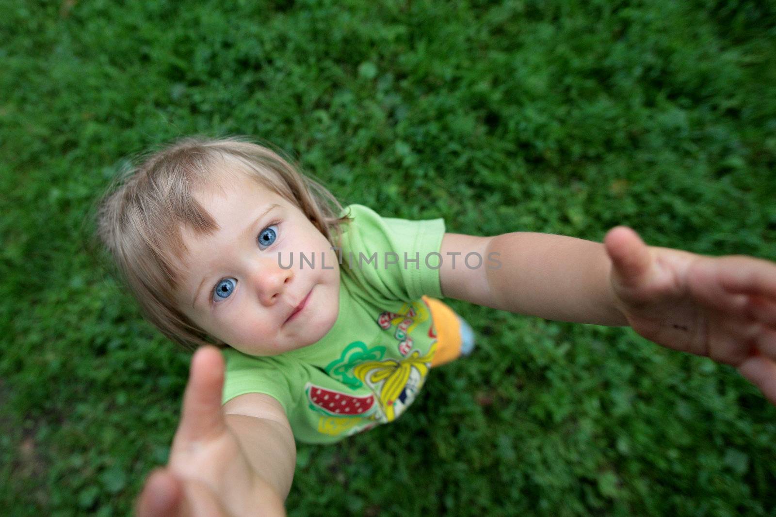 little happy girl with hands up, top view