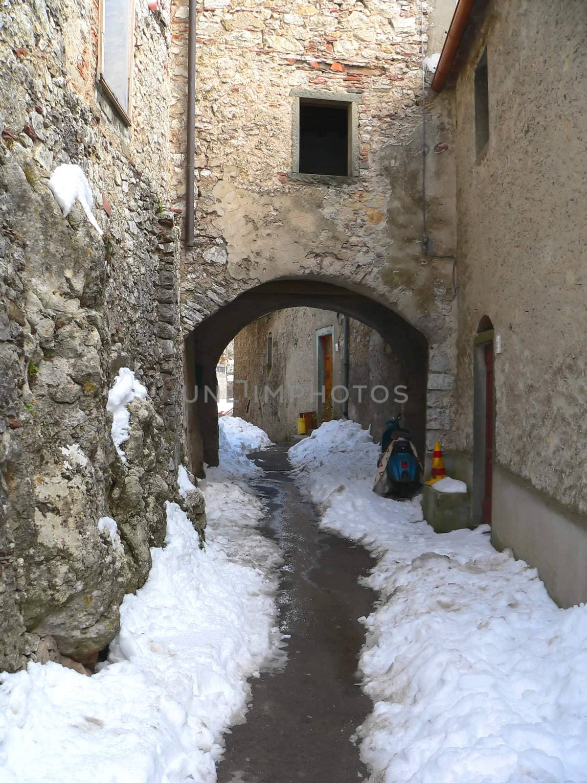medieval village with snow in tuscany