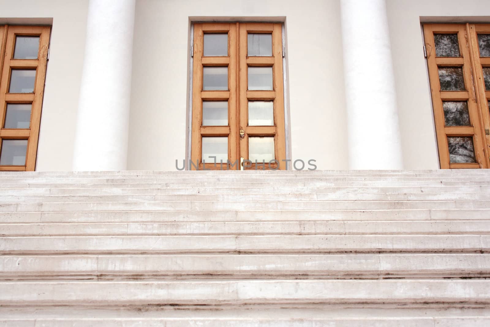 Marble stairs leading to three doors.