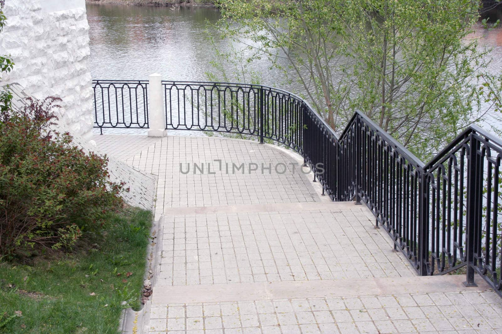 Winding stairs with metall banister, framing the pond within the Ostafyevo Manor 