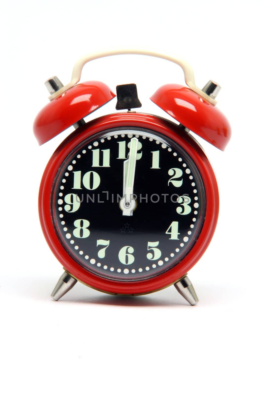 small red alarm clock at twelve oclock  isolated on white background