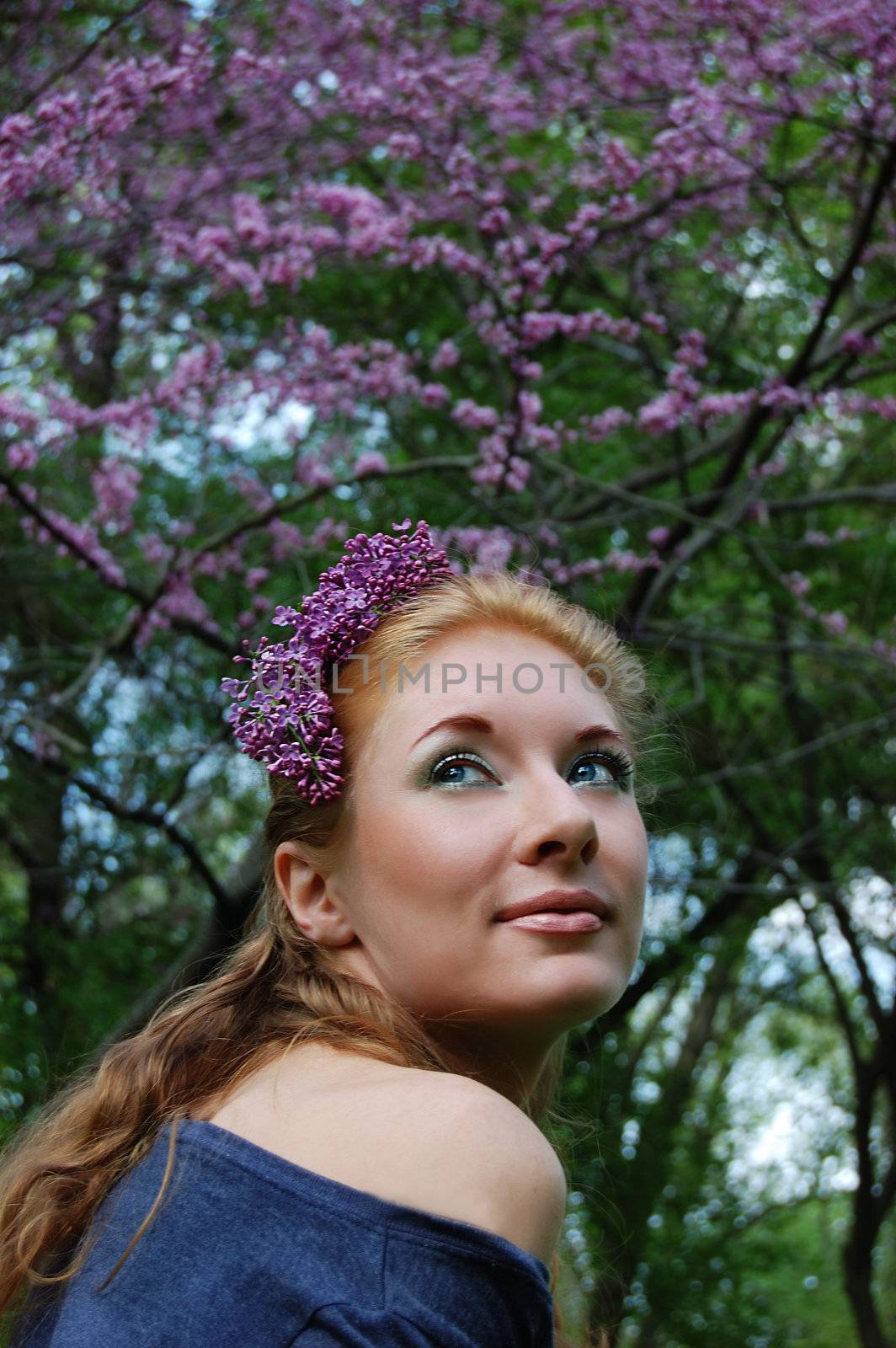 Beautiful girl in lilac blossom