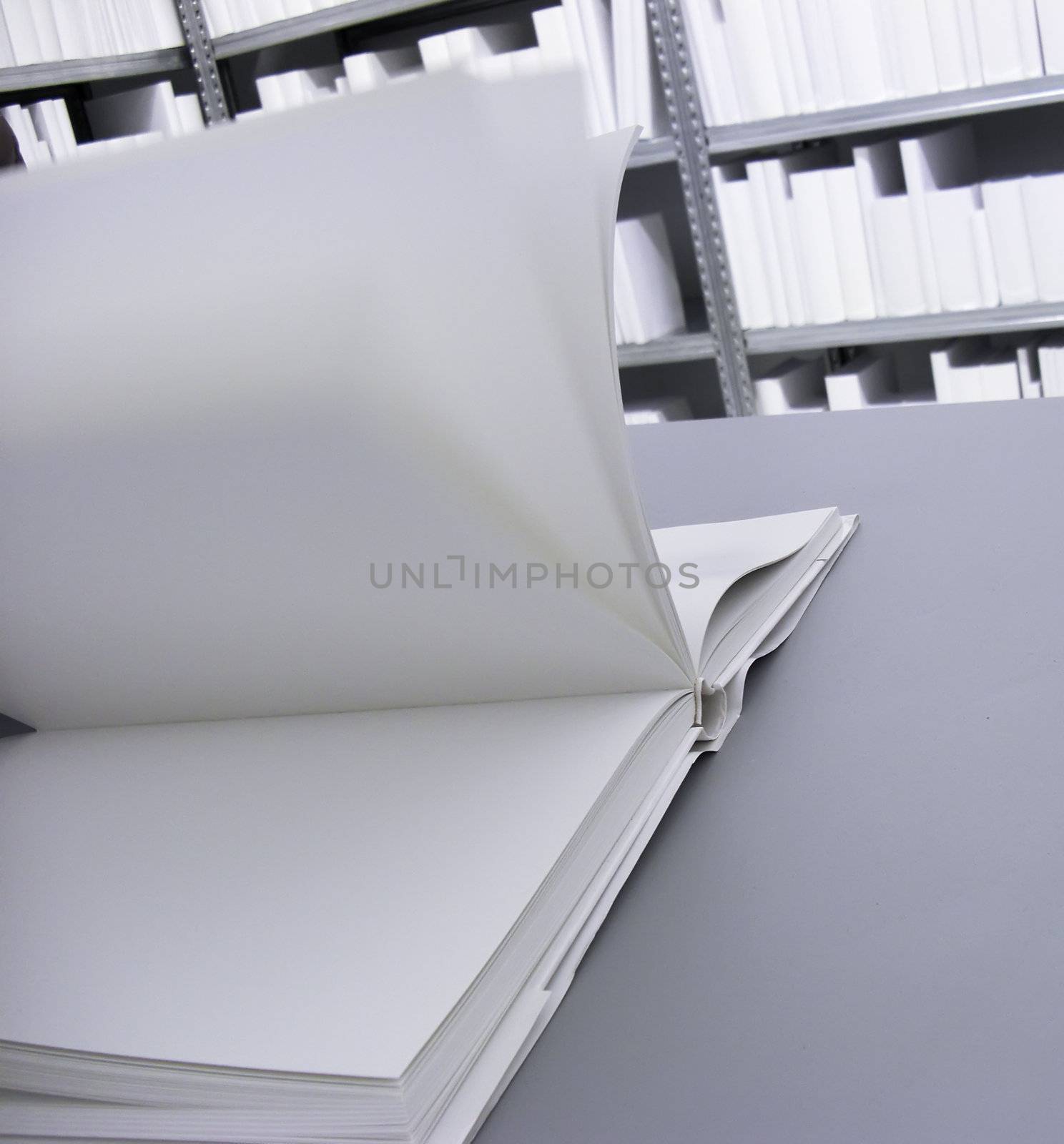 Open white Book with blank Pages in a white Library