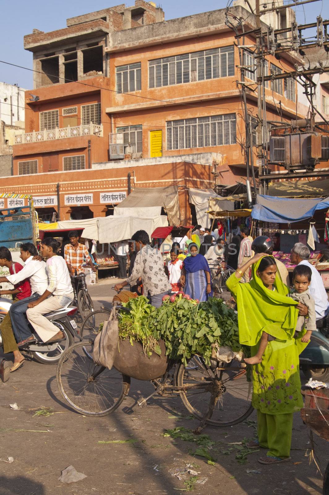 People going about their business in a crowded street in Jaipur, Rajasthan, India.
