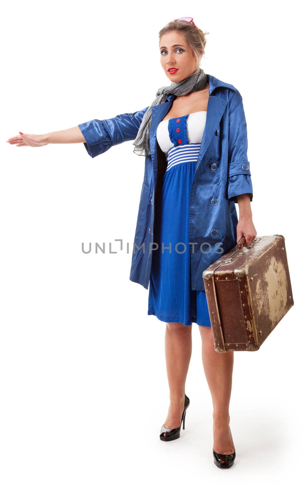 young woman dressed in retro style with an old suitcase