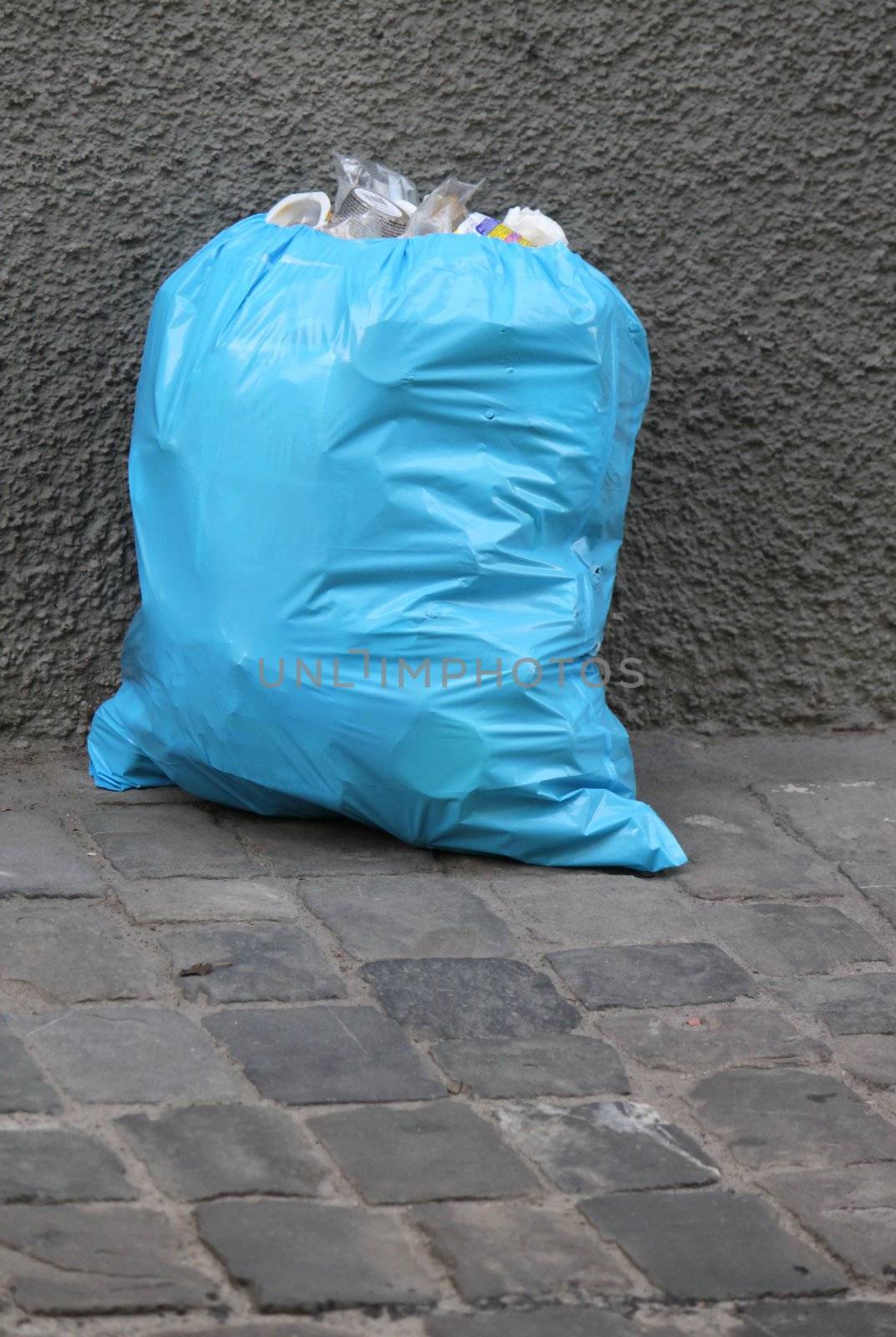 One blue garbage pack in the street
