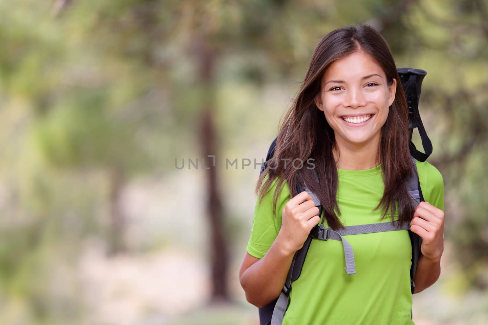 Woman hiking portrait with copy space. Fresh and healthy looking female model during hike outdoors in forest. Beautiful mixed race Caucasian / Chinese Asian young woman. Image from volcano Teide, Tenerife, Canary Islands, Spain.