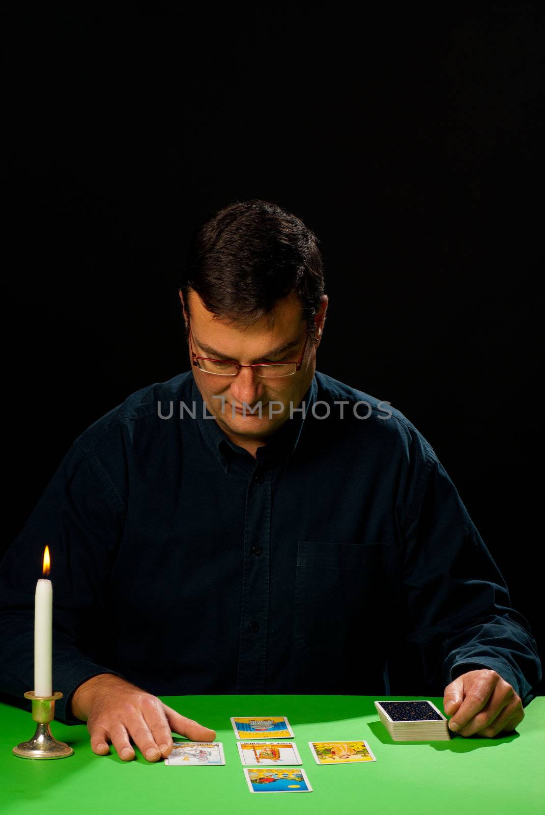 Tarot reader having a concentrated look at a spread of cards