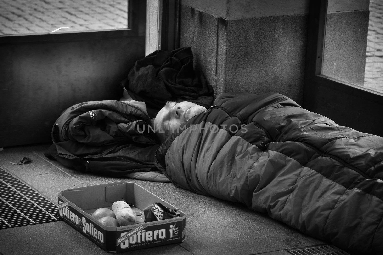 STOCKHOLM, SWEDEN - OCT. 29: An unidentified homeless man sleeping at the entrance to the subway in Stockholm, Sweden on October 29, 2010. There are about 5,000 homeless people in Stockholm, where the population is 1.3 million.