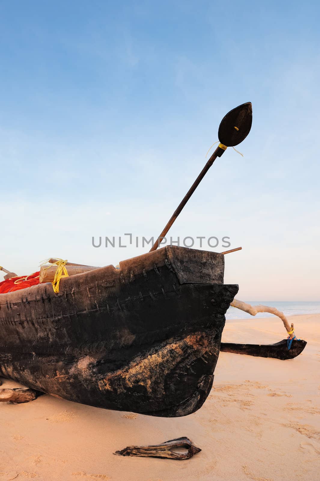 Wooden old fishing boat on the sandy shore