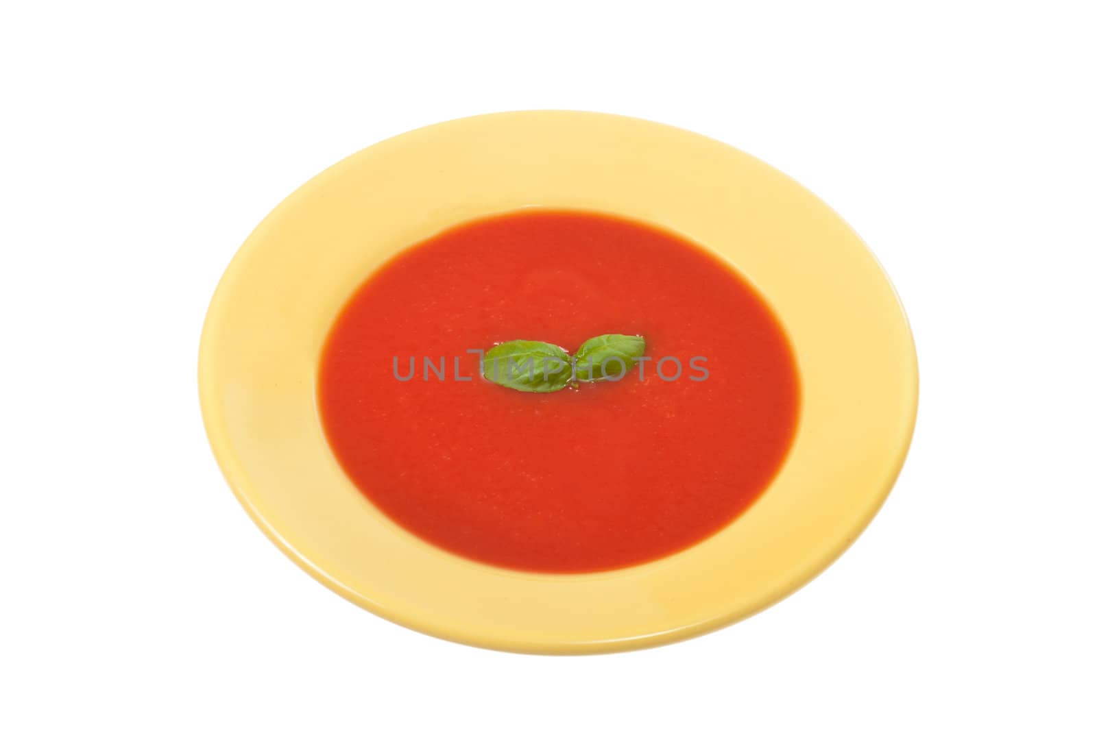 tomato soup in yellow plate, photo on white 