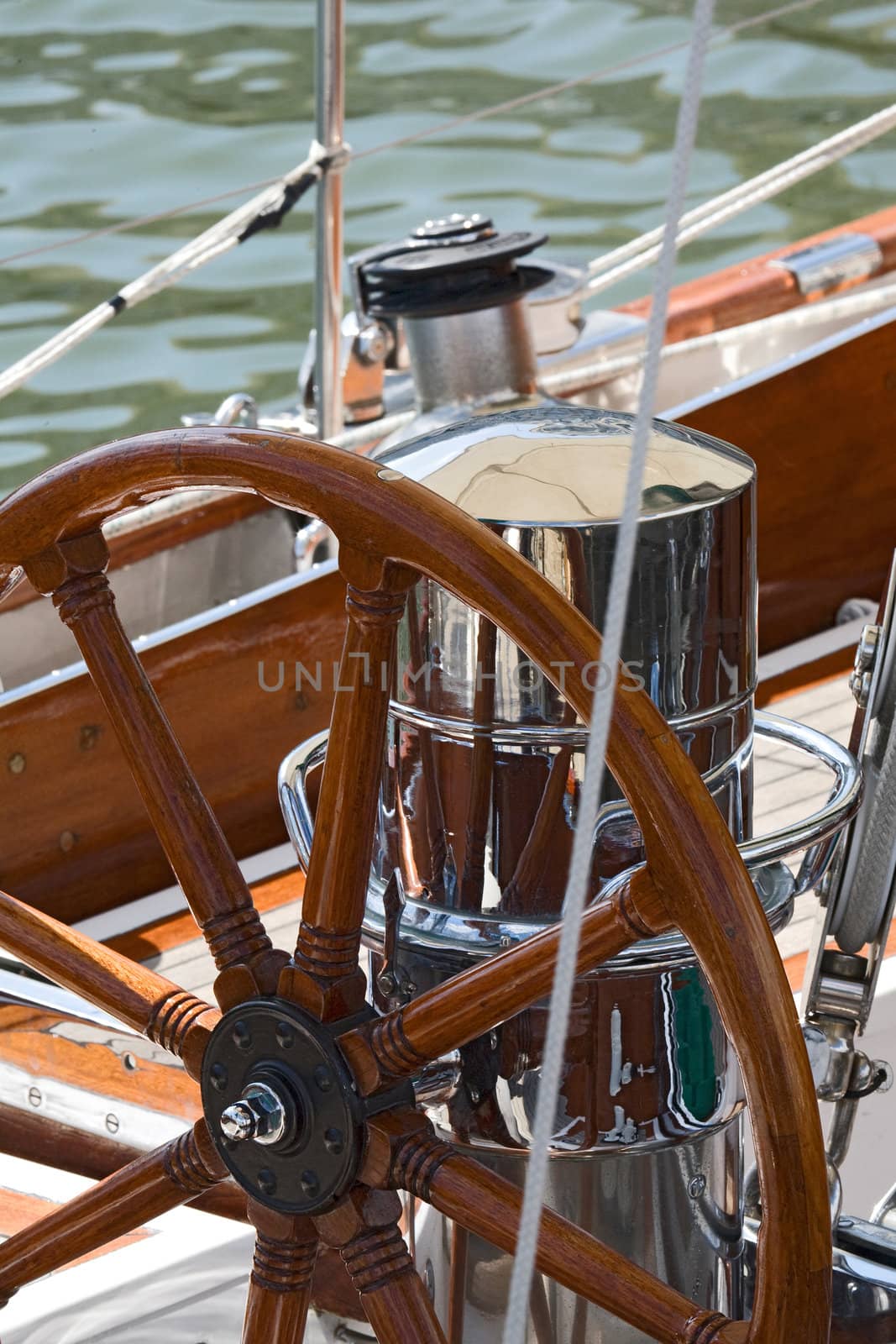 Detail of an old-fashioned boat deck with rudder and other navigation tools 