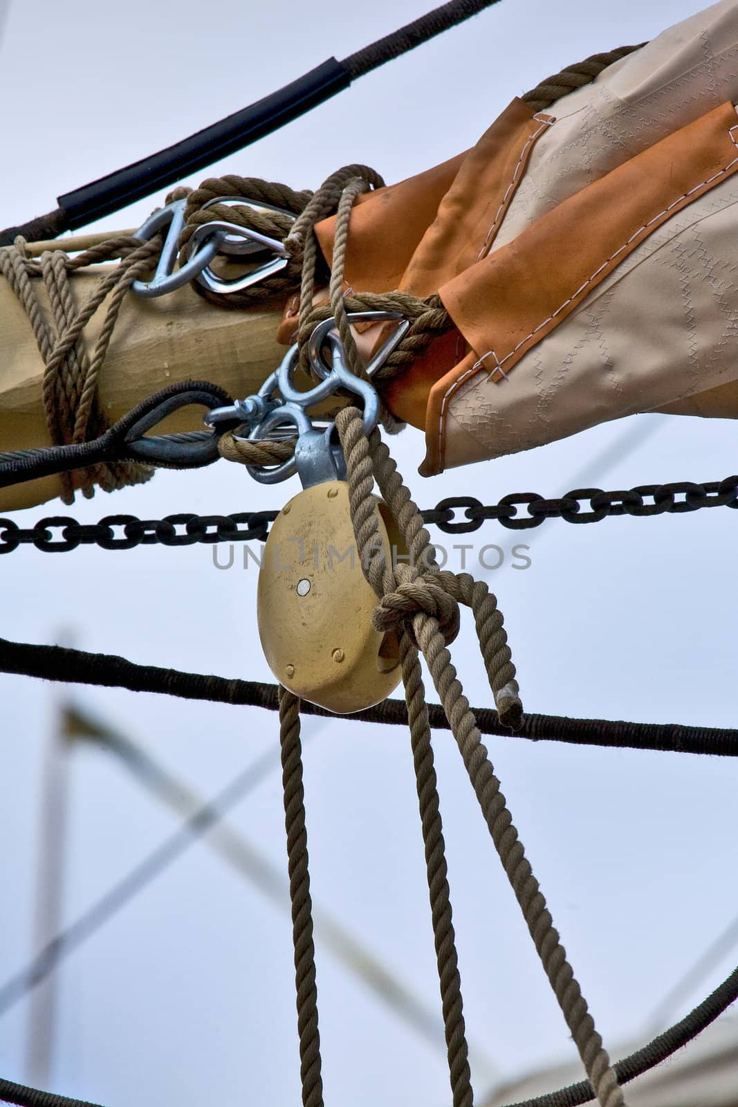 Old wooden block with rope and sail