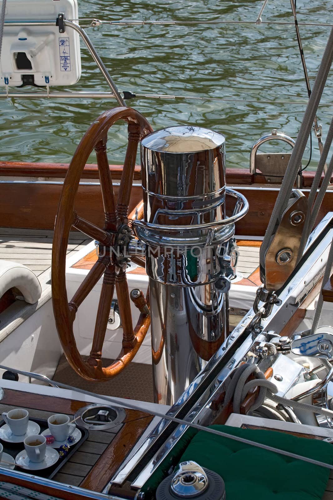 Rudder and coffee cup on a wooden boat 