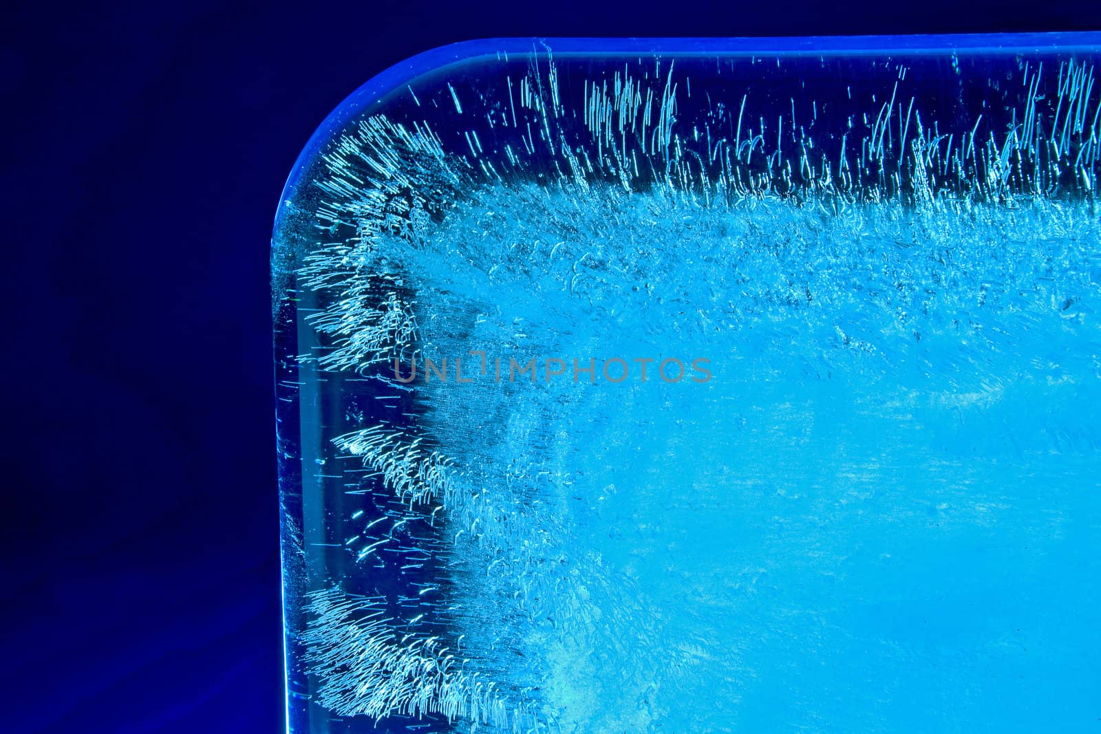 Ice Cube on blue background and hard white light