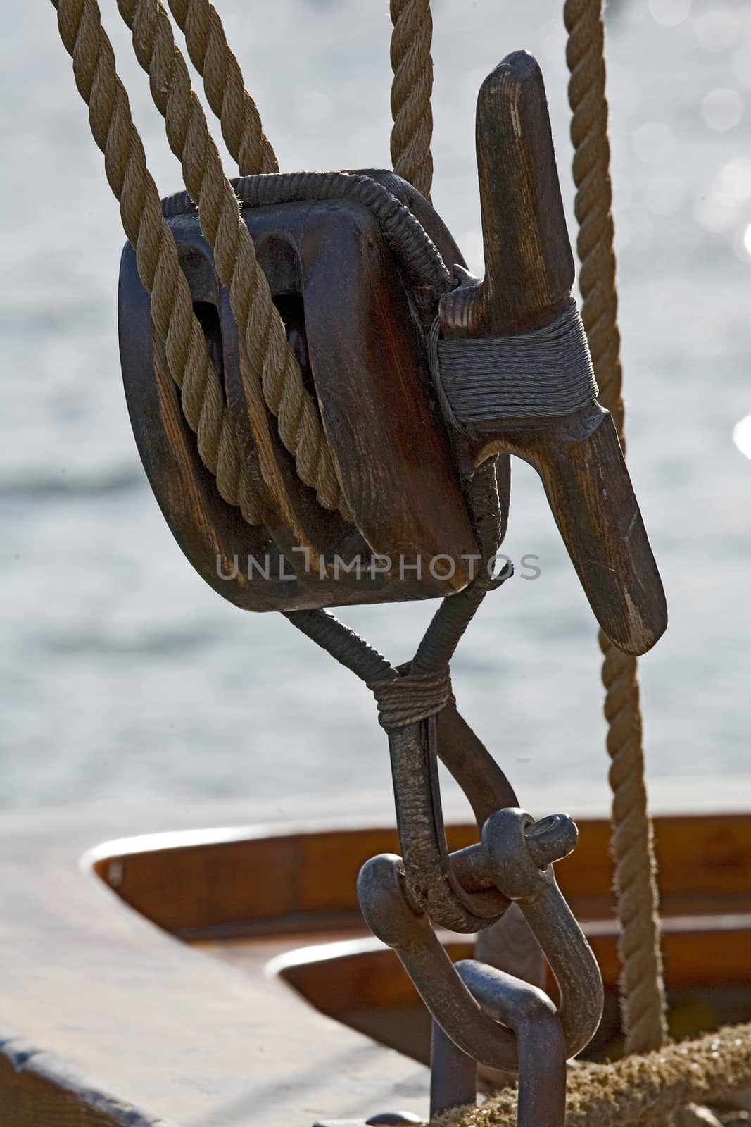 Old wooden block with rope. 