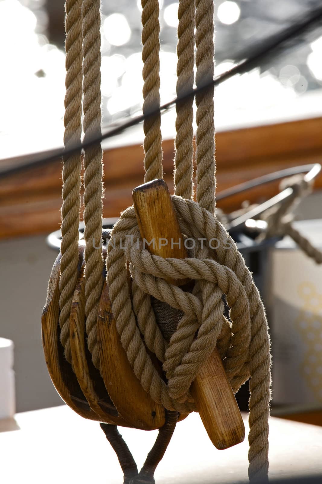 Old wooden block with rope. 