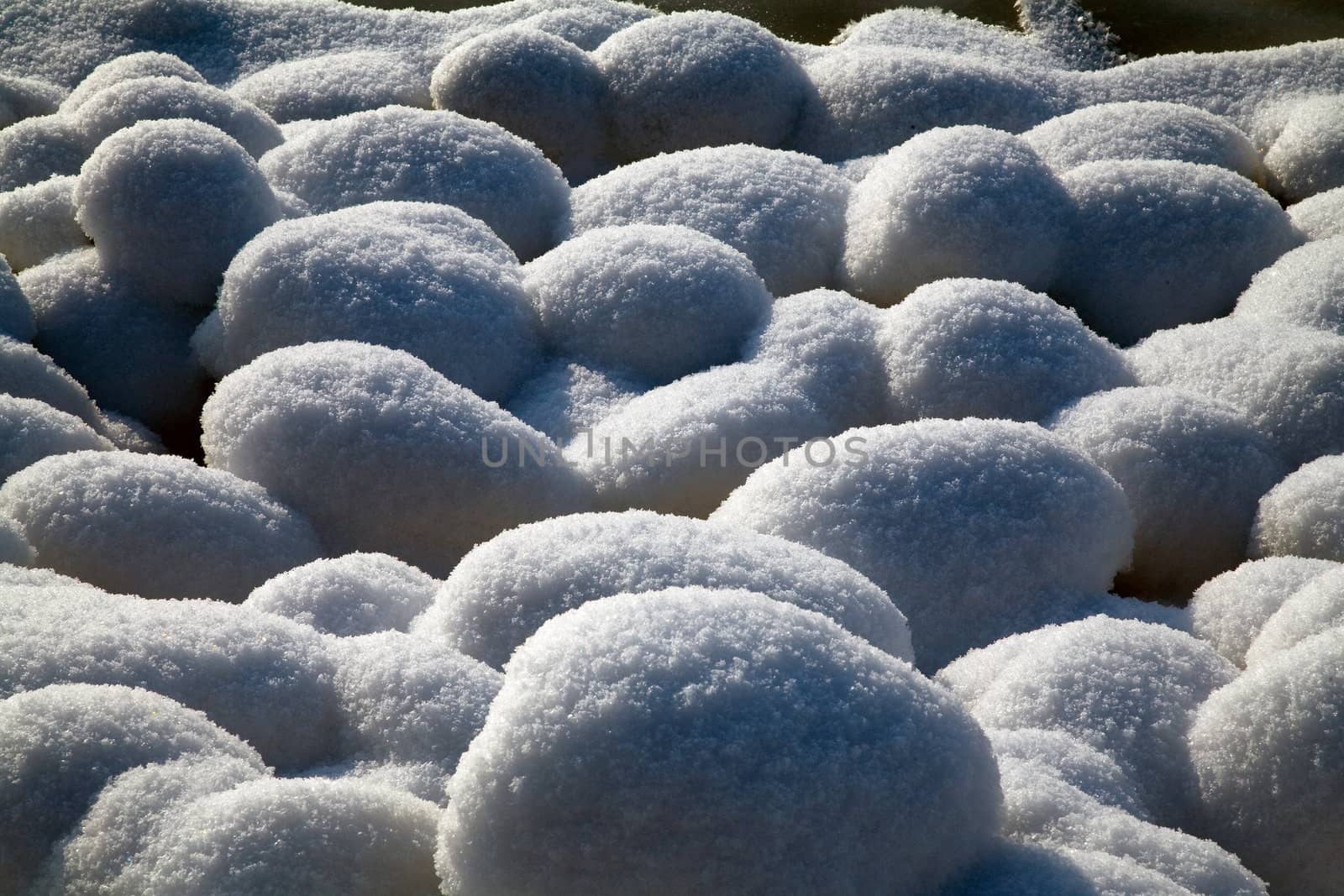 Snow stones covered with hard sunshine