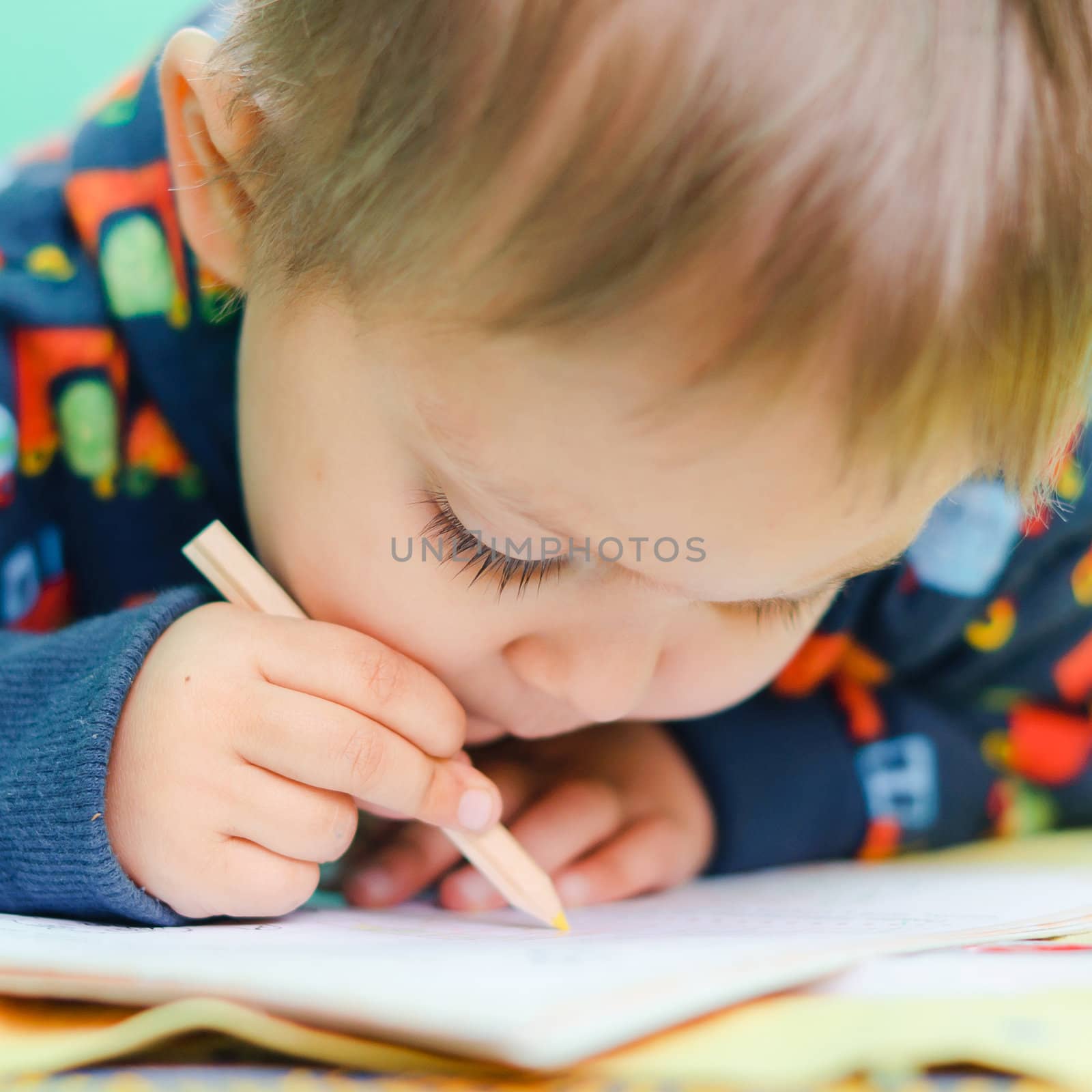 Little Boy Drawing. child playing with crayons