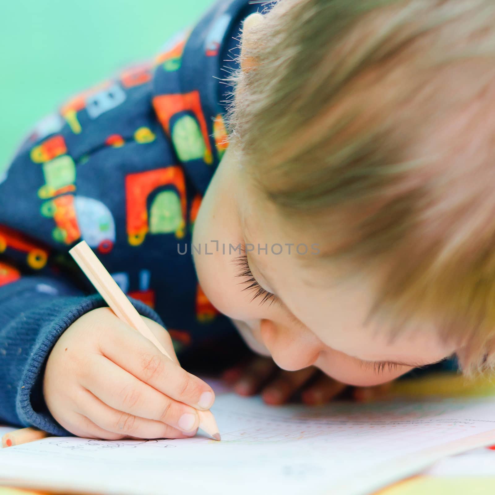 Little Boy Drawing. child playing with crayons