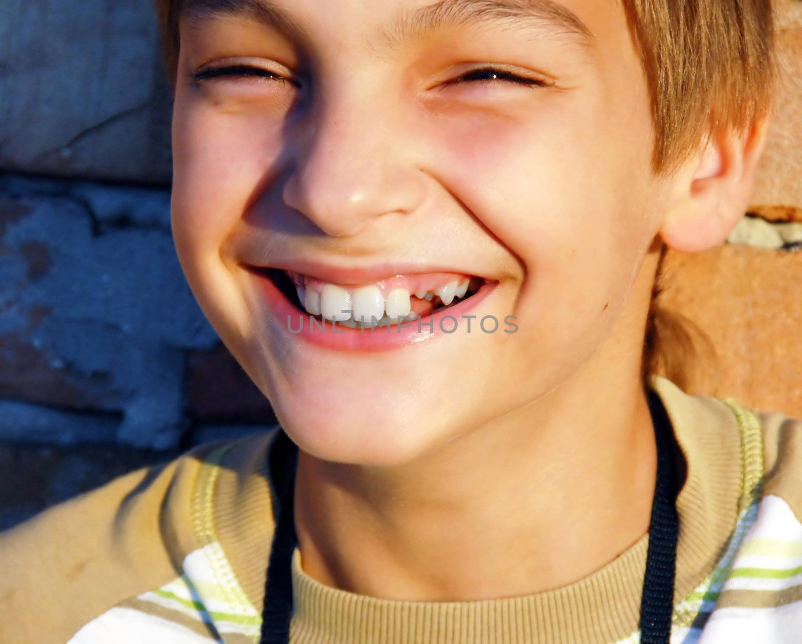 laughing teen caucasian boy with missing tooth portrait